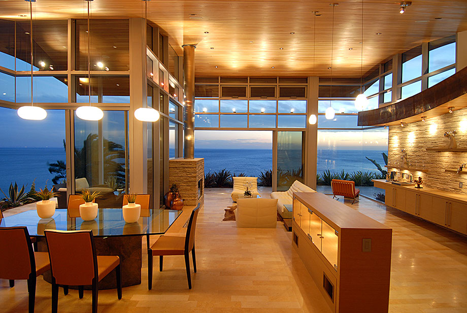 Double-height living room opening to the ocean